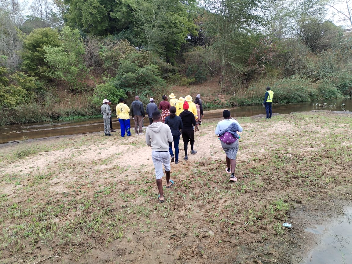 Community members walking down to the river.
