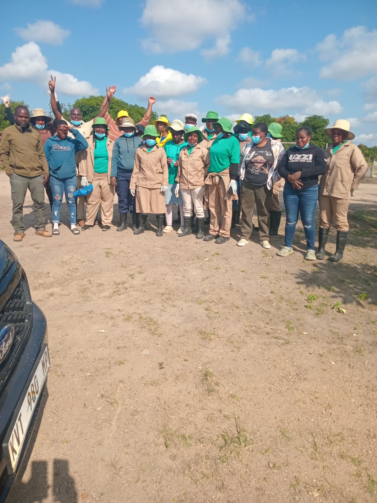 The team at the close of the day, hands raised.