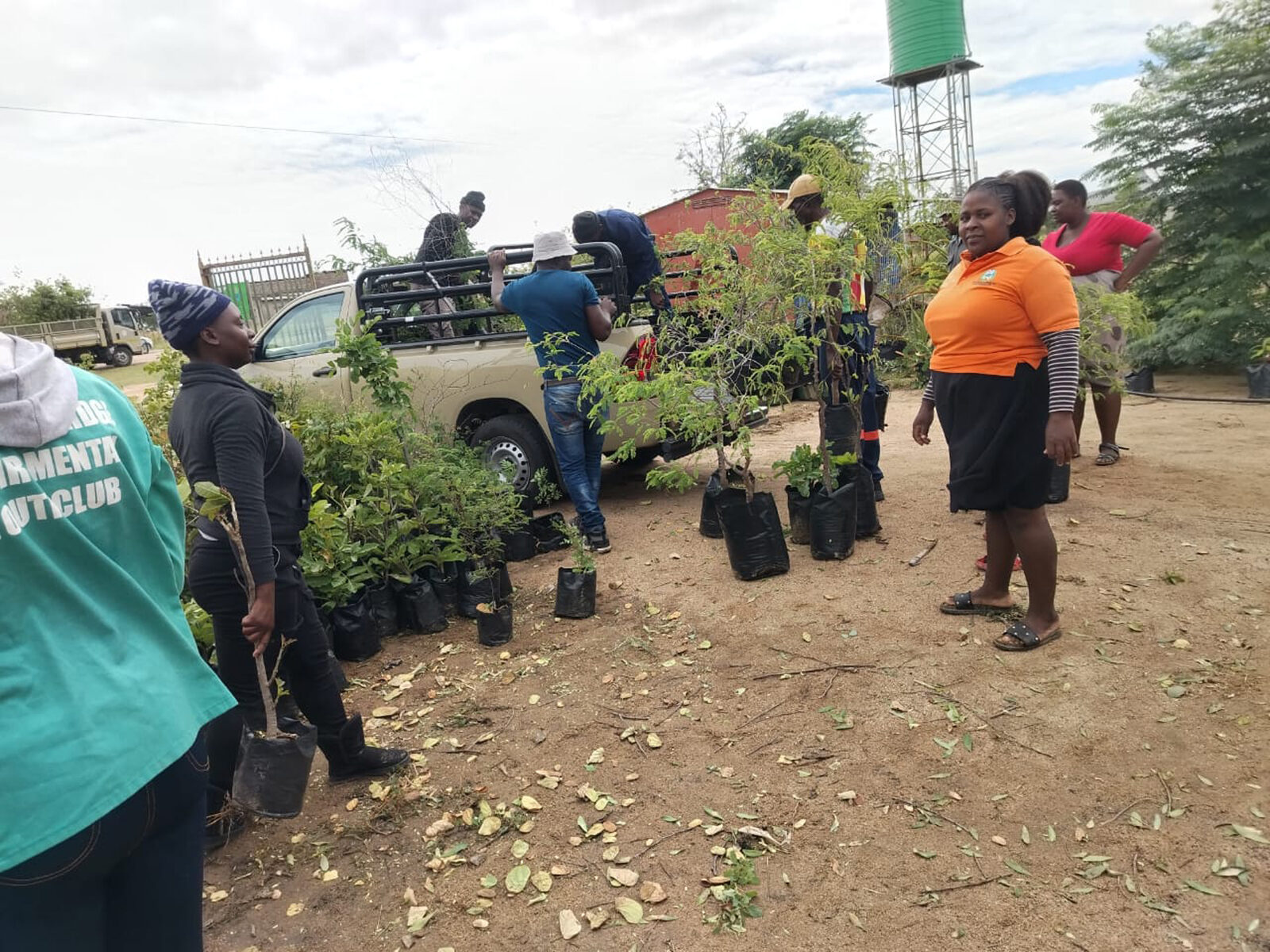 Operators and community workers at Ntirhisano load saplings into the back of a SANParks pickup for transport to the planting site.