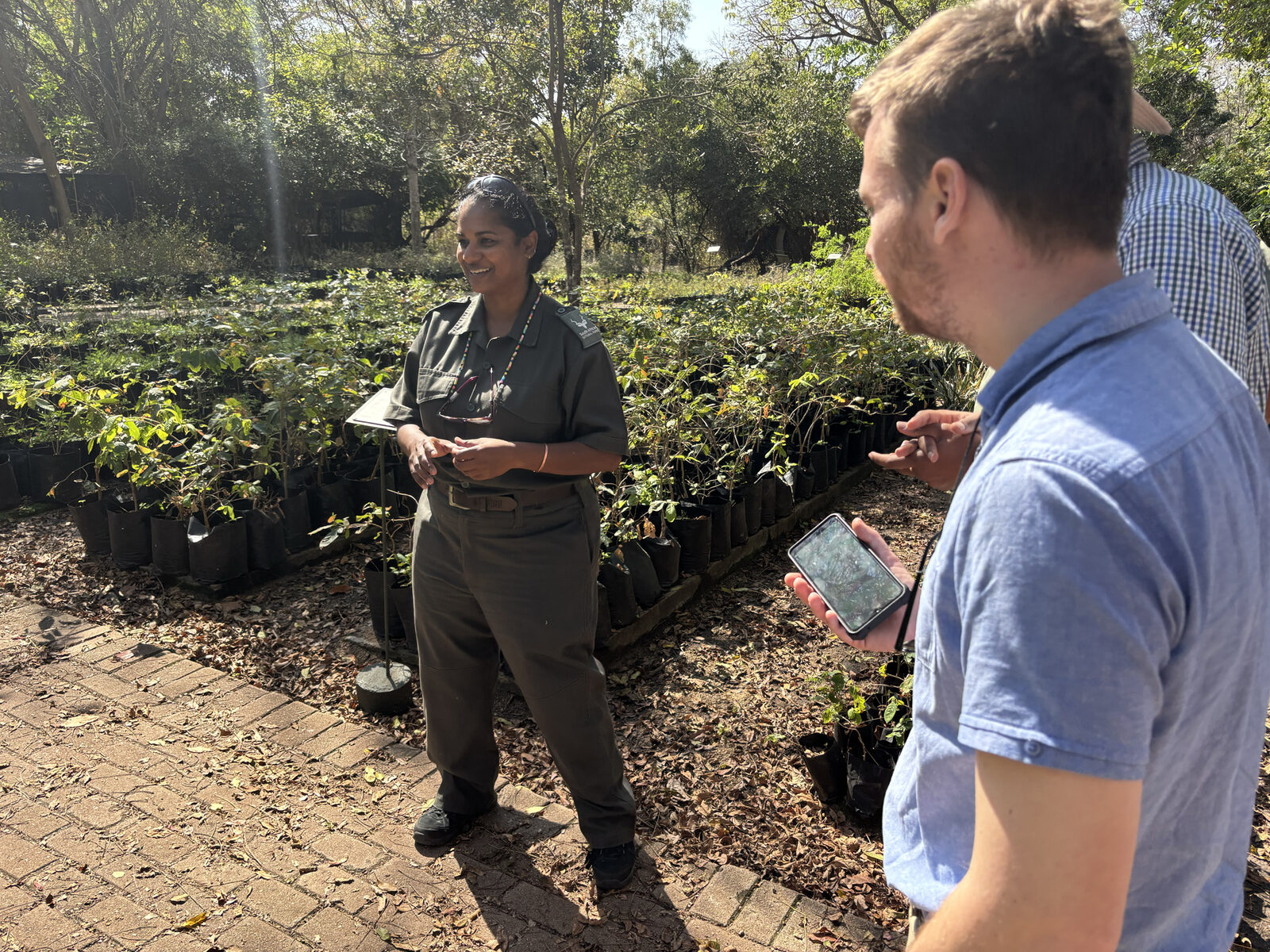 A SANParks nursery technical lead speaks with project team members at the Skukuza nursery.