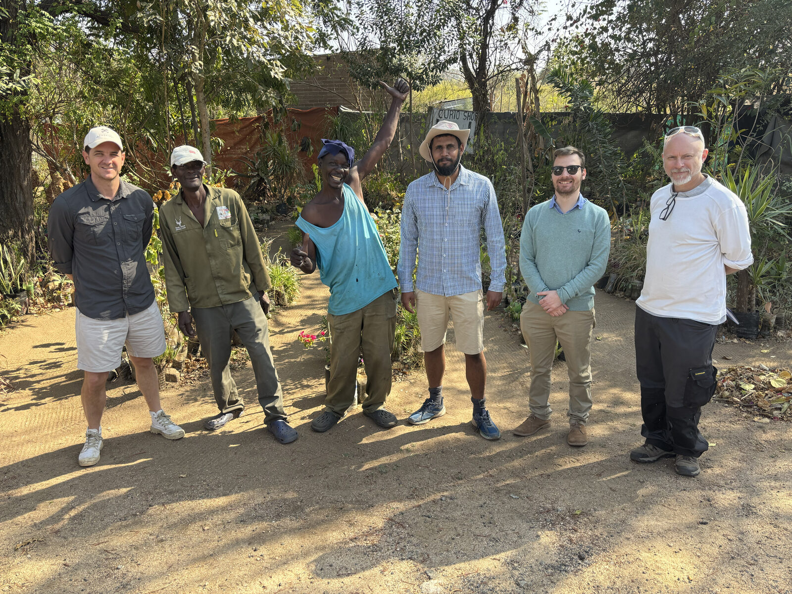 Project team members and nursery operators stand together at Tiyimeleni Nursery during a site visit.